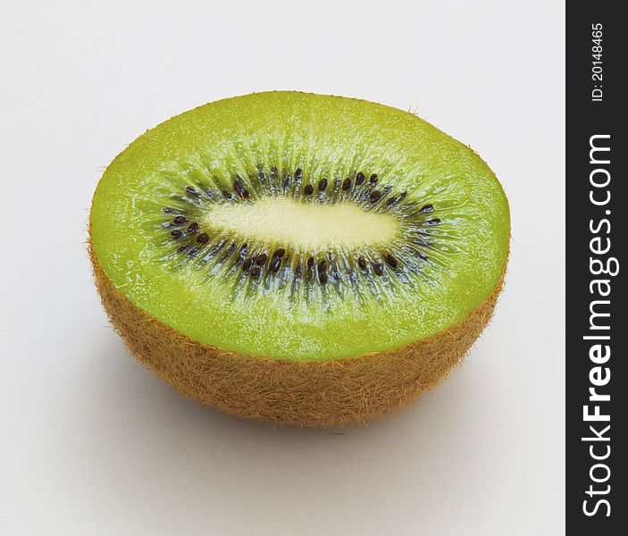 Half of organic kiwi fruit on a white background