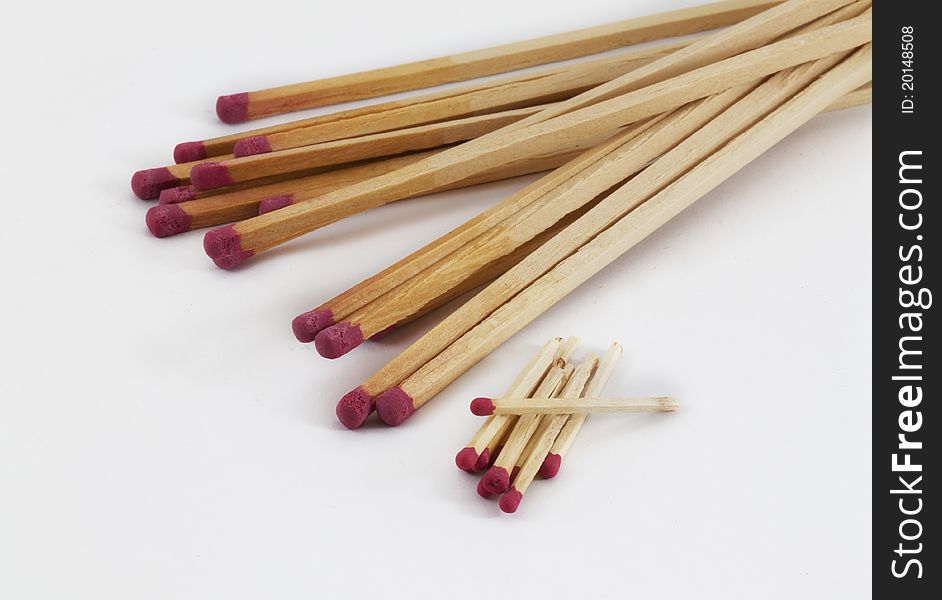 Large and small matches on a white background