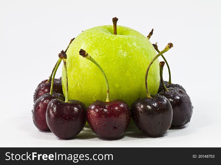 Cherrys and green apple on white background. Cherrys and green apple on white background.