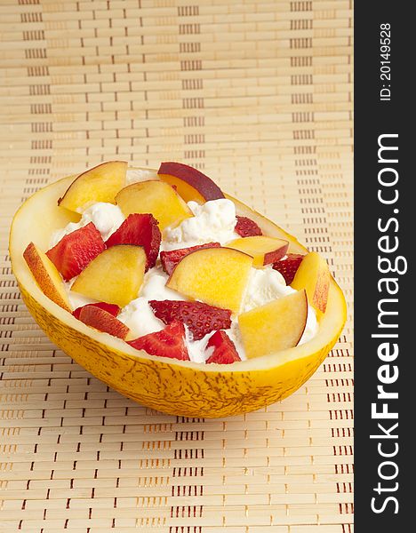 Ice cream with strawberries, melon and peach. Ice cream with strawberries, melon and peach