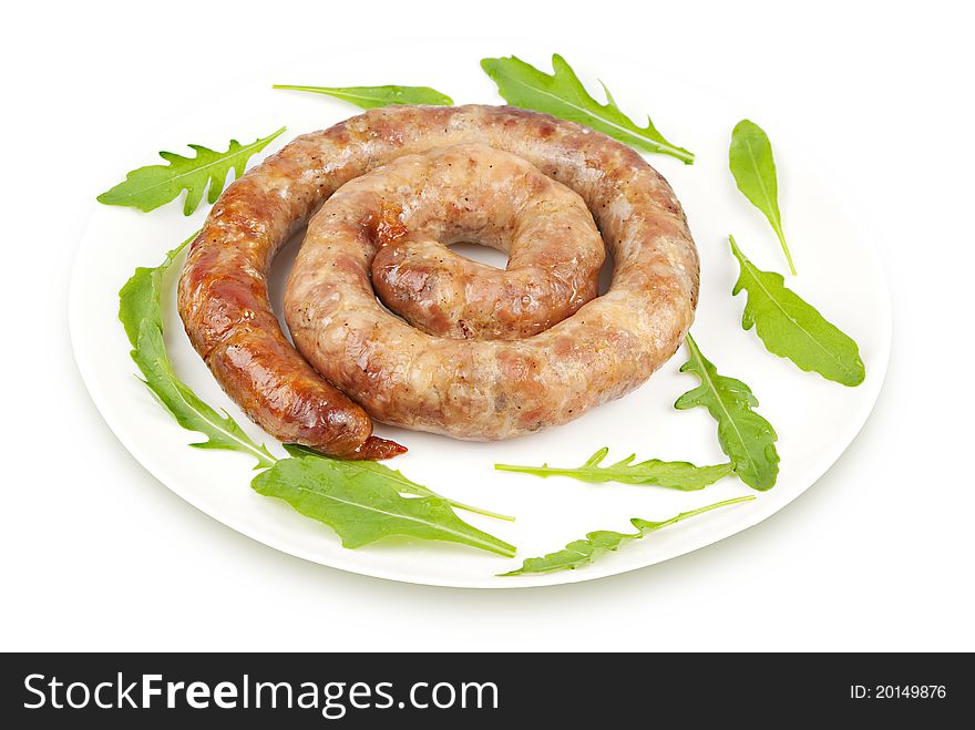 Ring sausage fried with arugula