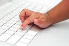 Little Finger Of A Kid Typing On Keyboard Stock Photo