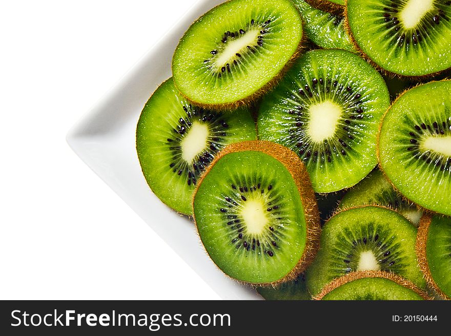 Kiwi fruit on a white plate and background.