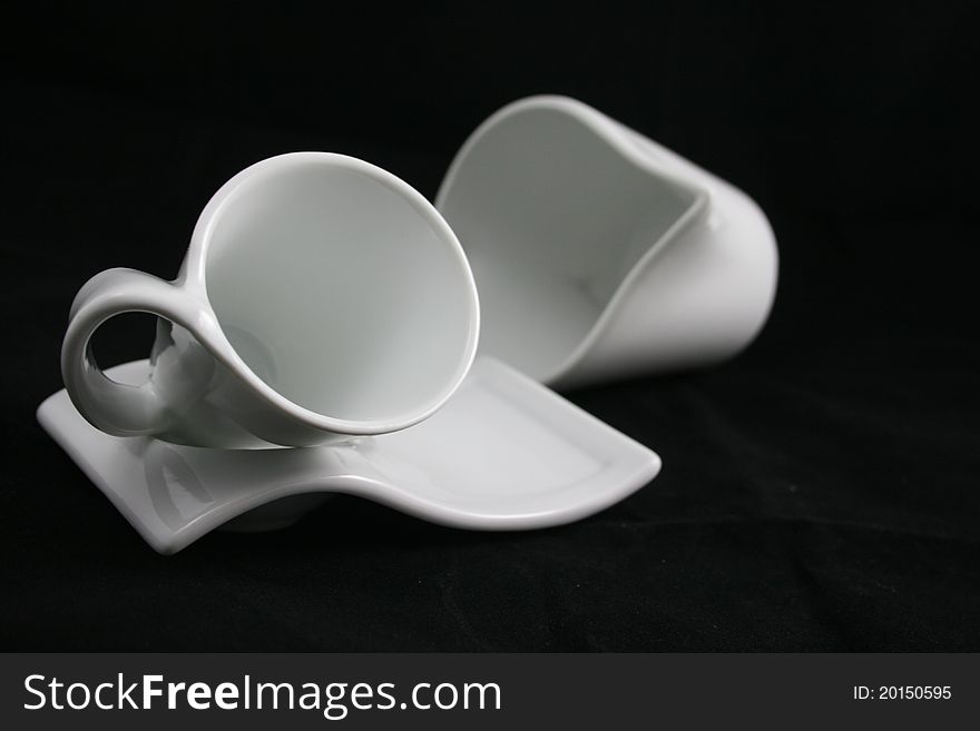 A white cup with its milk jug. A white cup with its milk jug.