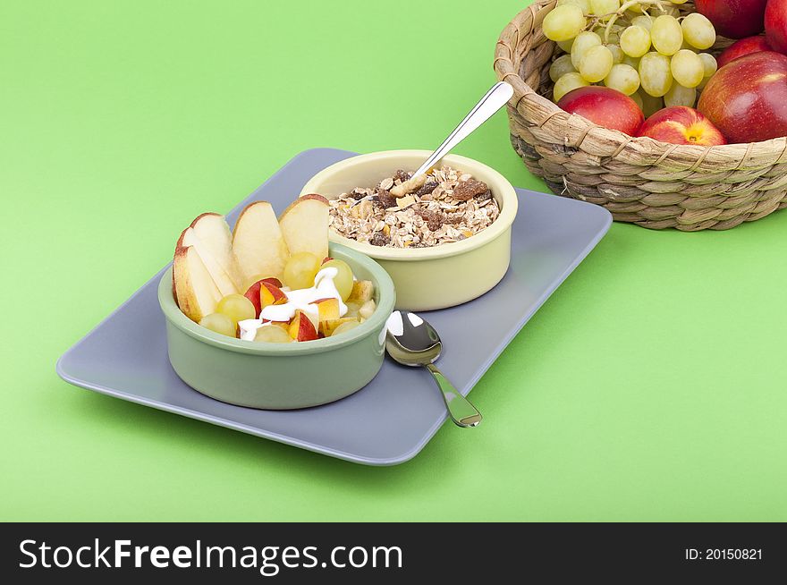 Studio-shot of a plate with fresh fruits, muesli and yogurt. bowl full with grapes, nectarines and apple. Studio-shot of a plate with fresh fruits, muesli and yogurt. bowl full with grapes, nectarines and apple.