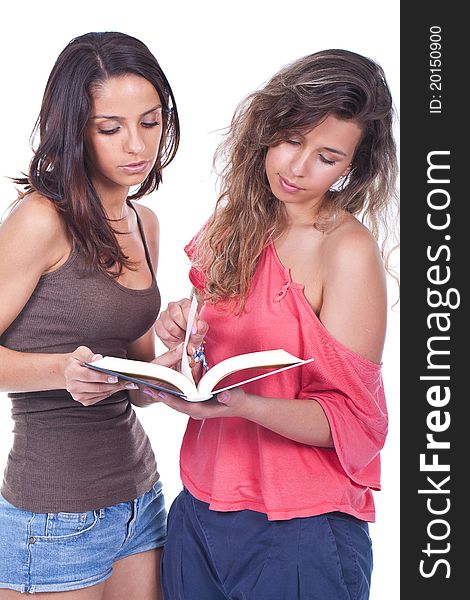 Two beautiful women standing and reading a book. Two beautiful women standing and reading a book