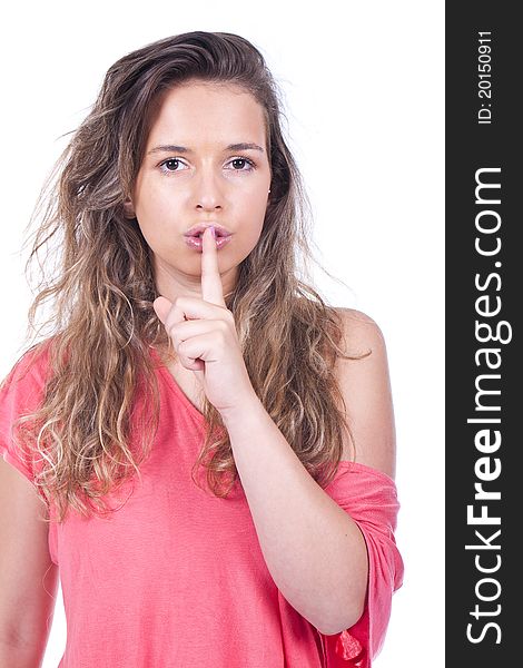 Young and beautiful woman doing silence sign with her finger on the lips