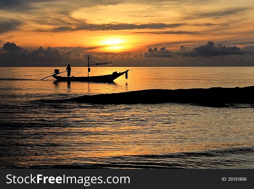 Spectacular sunset with fisherman in Thailand