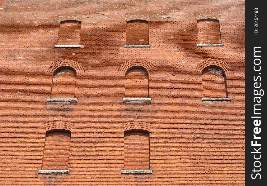 Bricked up windows in an old red brick building. Bricked up windows in an old red brick building.