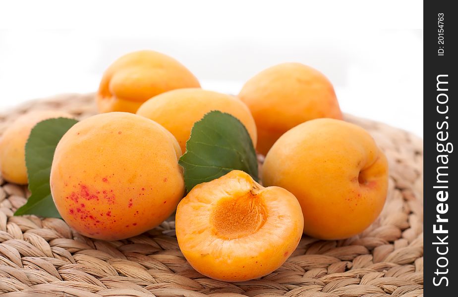 Fresh apricots in a straw cloth