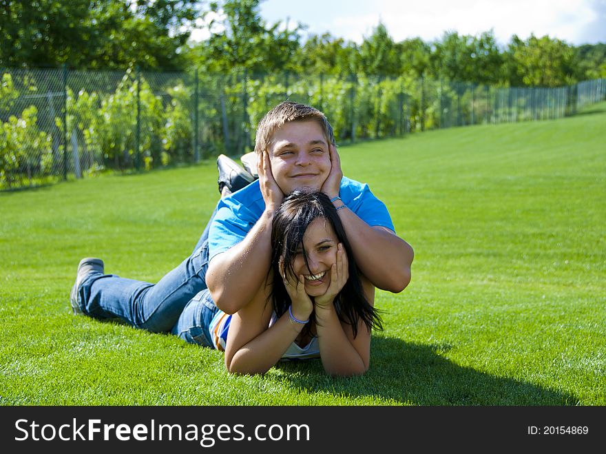 Two young people lying on the grass. Two young people lying on the grass