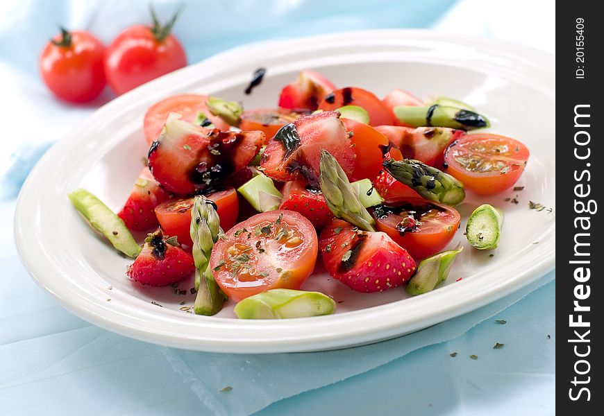 Fresh salad with strawberry, asparagus and tomato. Selective focus
