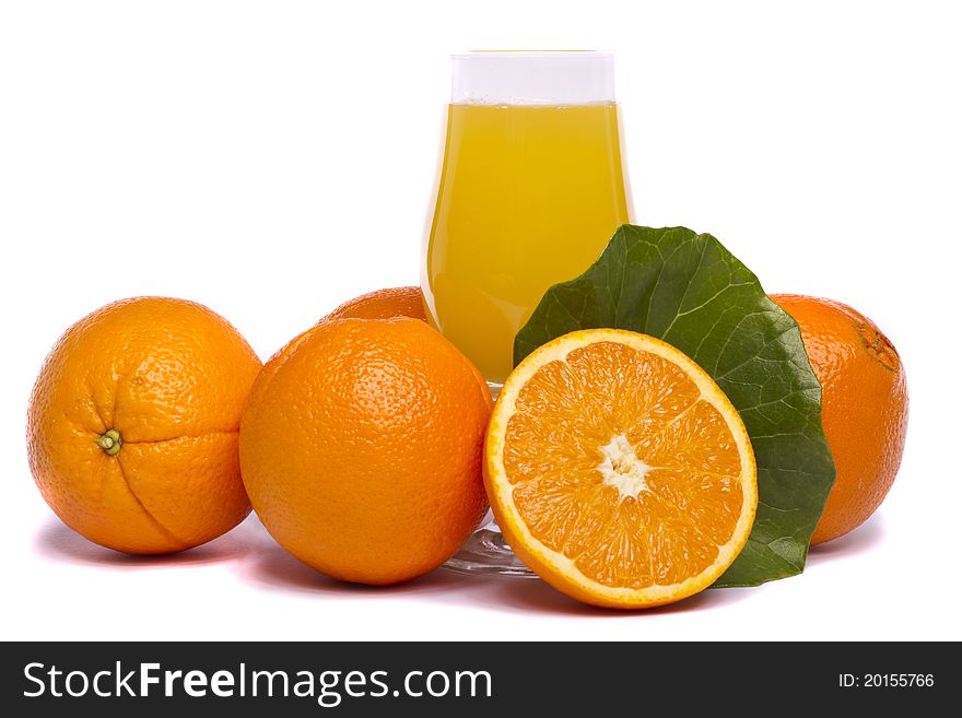 Close view of a bunch of oranges with glass of juice, isolated on a white background. Close view of a bunch of oranges with glass of juice, isolated on a white background