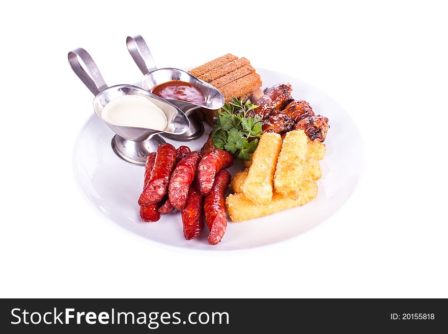 Meat dish with various meats, chicken, sausage, toast, potatoes. Meat dish with various meats, chicken, sausage, toast, potatoes.