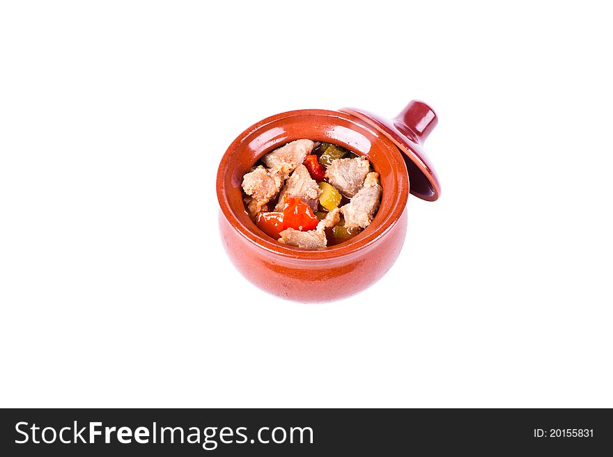Meat with vegetables in a pot with a lid. On a white background. Meat with vegetables in a pot with a lid. On a white background.