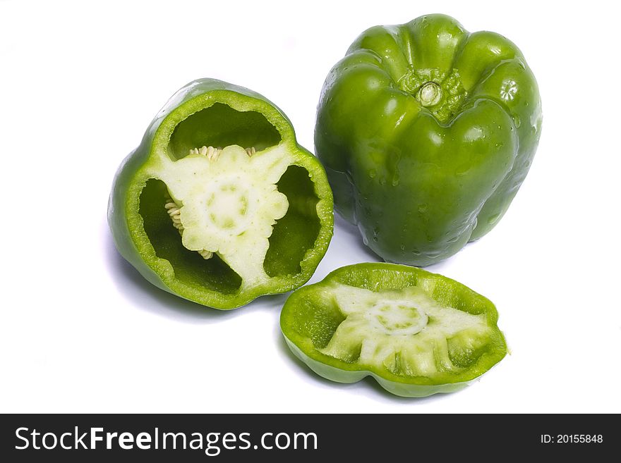 Close view of a green bell pepper isolated on a white background.
