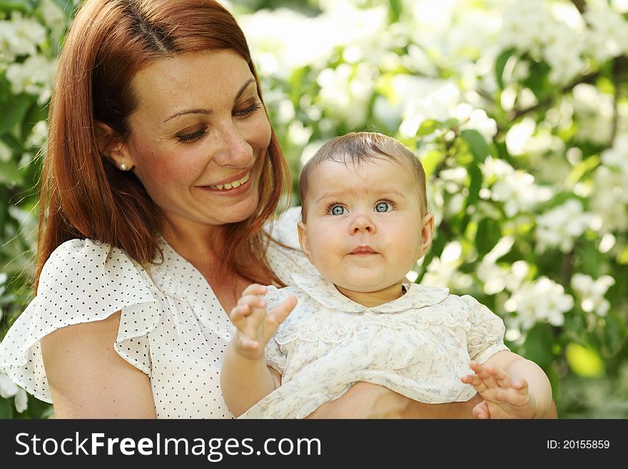 Mother and daughter close up portrait on flower background