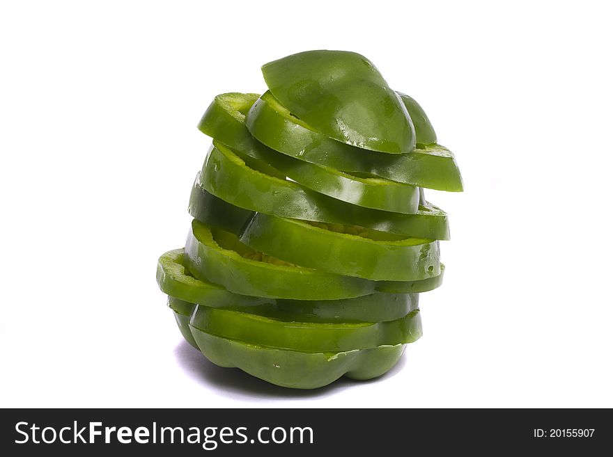 Close view of a green bell pepper isolated on a white background.