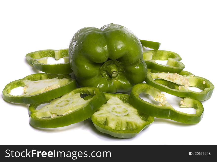 Close view of a green bell pepper isolated on a white background.