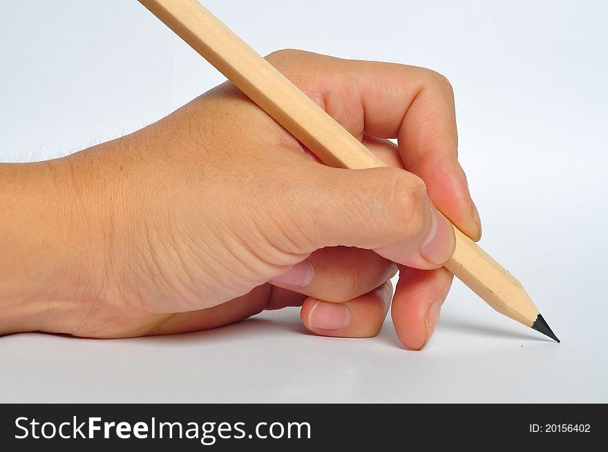 Hand holding a pencil and preparing to write. Hand holding a pencil and preparing to write.