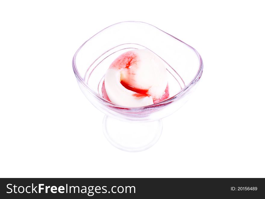 Strawberry ice cream in a glass beaker. On a white background