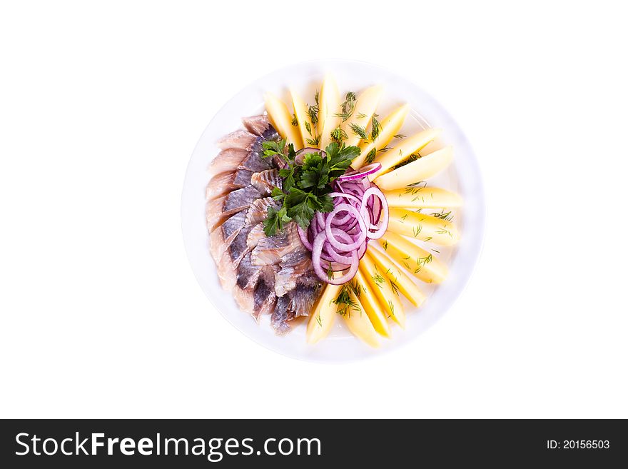 Sliced вЂ‹вЂ‹herring with potatoes and onions to a plate. Sliced вЂ‹вЂ‹herring with potatoes and onions to a plate.