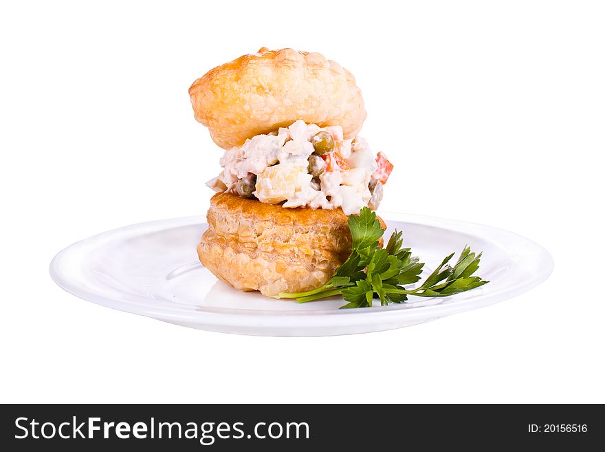 Plate with a tartlet filled with a salad. Plate with a tartlet filled with a salad.