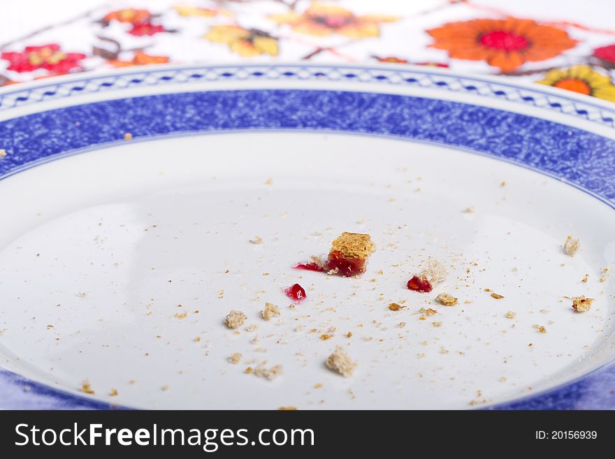 Close view of a dish with crumbs of toasted bread with jam.