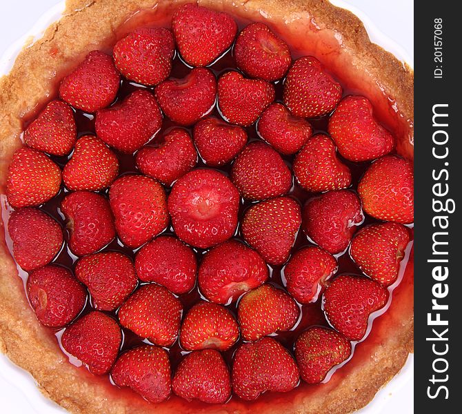 Strawberry Tart in a tart pan on a white background