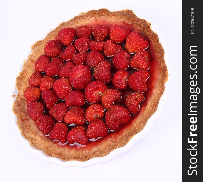 Strawberry Tart in a tart pan on a white background