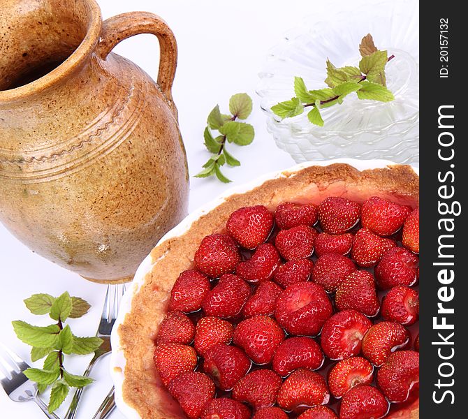 Strawberry Tart, plates, a pot, forks and mint twigs
