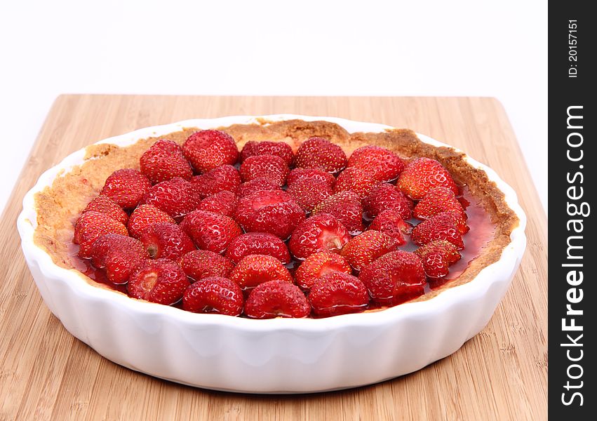 Strawberry Tart in a tart pan on a wooden background