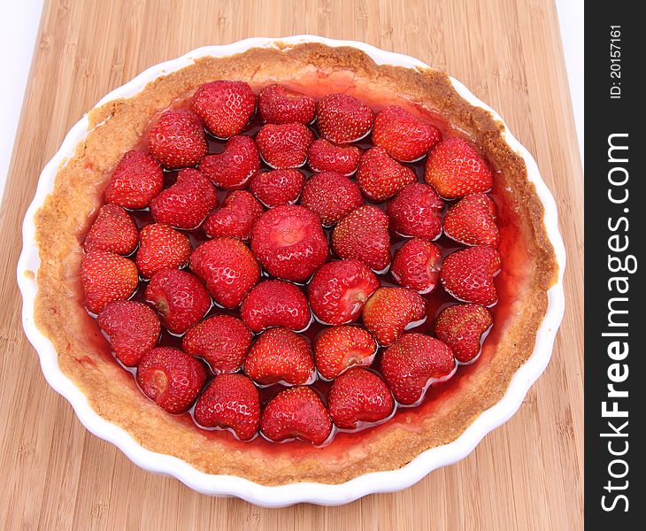 Strawberry Tart in a tart pan on a wooden background