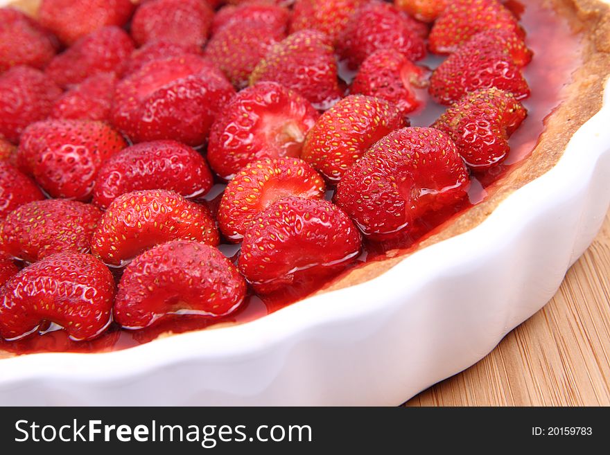 Strawberry Tart in a tart pan on a wooden background