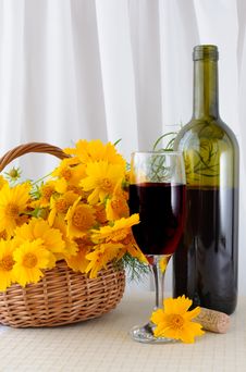 A Bottle Of Rose Wine With A Glass And Flowers Stock Images