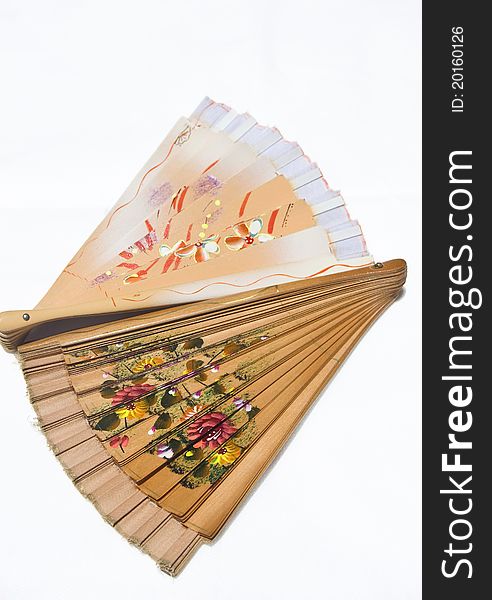 Shot of two folded Spanish fans with floral ornament on white background. Shot of two folded Spanish fans with floral ornament on white background.