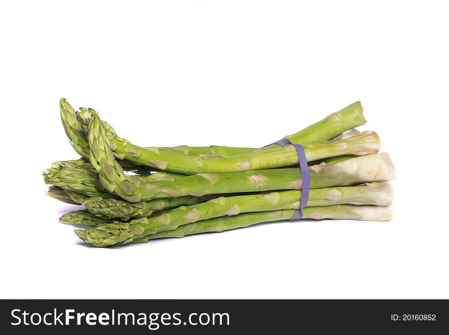Close up view of a bunch of asparagus vegetable isolated on a white background. Close up view of a bunch of asparagus vegetable isolated on a white background.
