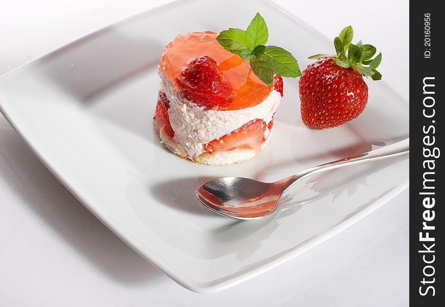 Strawberry cake on white plate