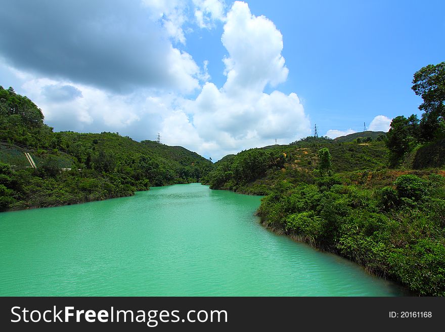 It is the landscape of a reservoir under summer time. It is the landscape of a reservoir under summer time.