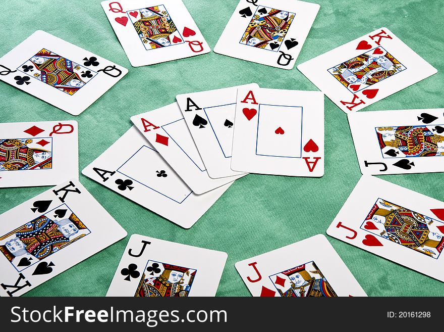 Close up view of a circle of playing cards spread on a green cloth table. Close up view of a circle of playing cards spread on a green cloth table.