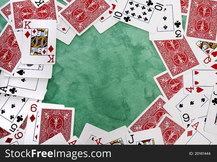 Close up view of a bunch cards spread on a green cloth table. Close up view of a bunch cards spread on a green cloth table.