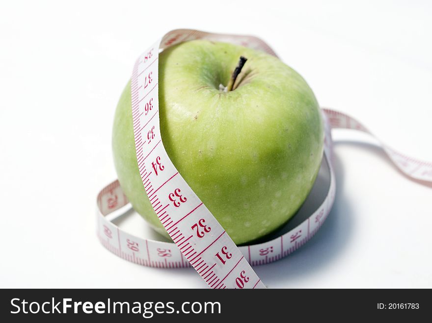 This is an image of apple with measuring tape. This is an image of apple with measuring tape.