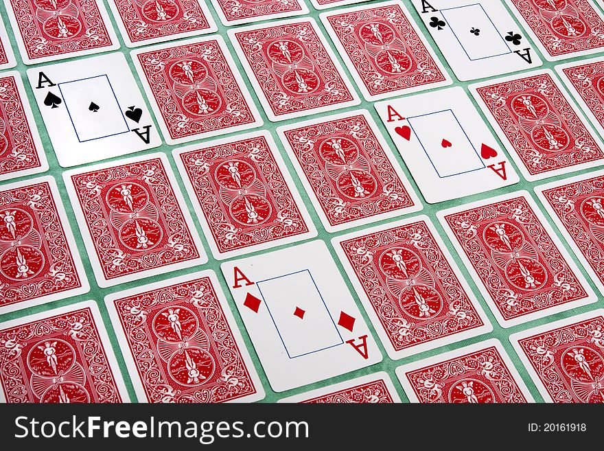 Close up view of a bunch of flipped playing cards spread on a green cloth table. Close up view of a bunch of flipped playing cards spread on a green cloth table.