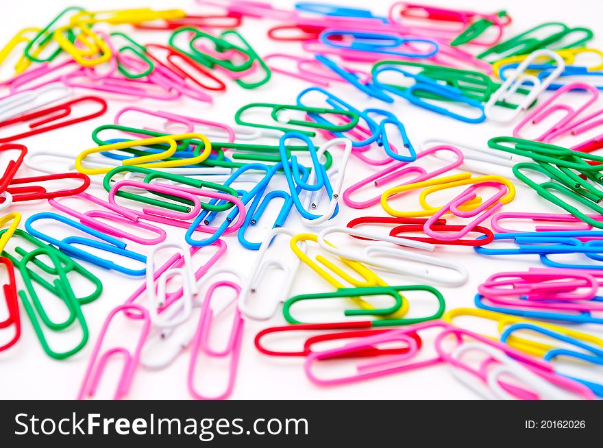 Colored paper clips. Isolated on white background