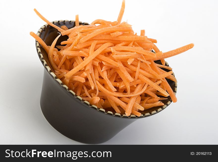 Shredded Raw Carrots In A Ceramic Bowl