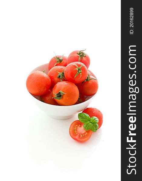 Photo of delicious tomatoes inside a bowl on white isolated background