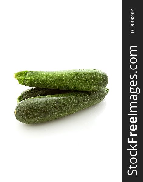 Photo of fresh zucchini on white isolated background