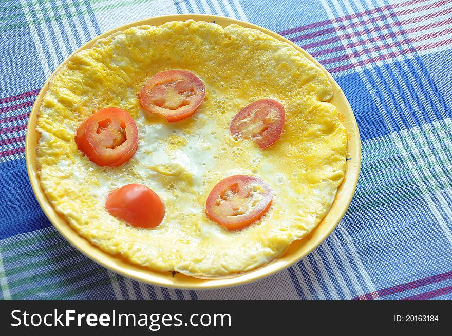 Omelet with tomato and cheese on the table