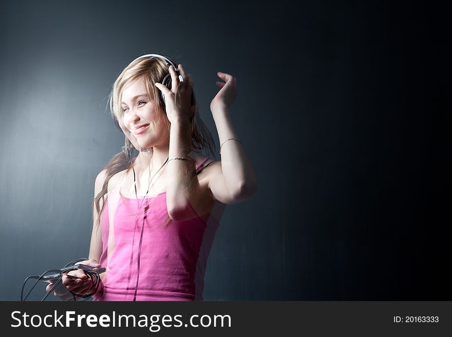 Music please! - Portrait of a pretty young woman/teenager listening to music on her hi-end headphones, enjoying the groove (multiple esposure shot)