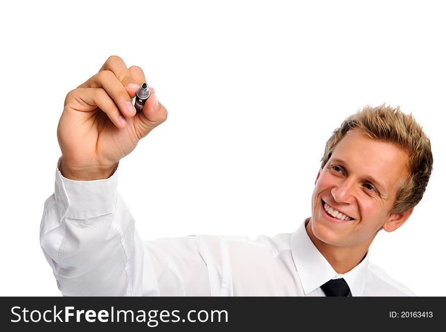 Good looking man in business attire holds a marker and writes in mid air. Good looking man in business attire holds a marker and writes in mid air